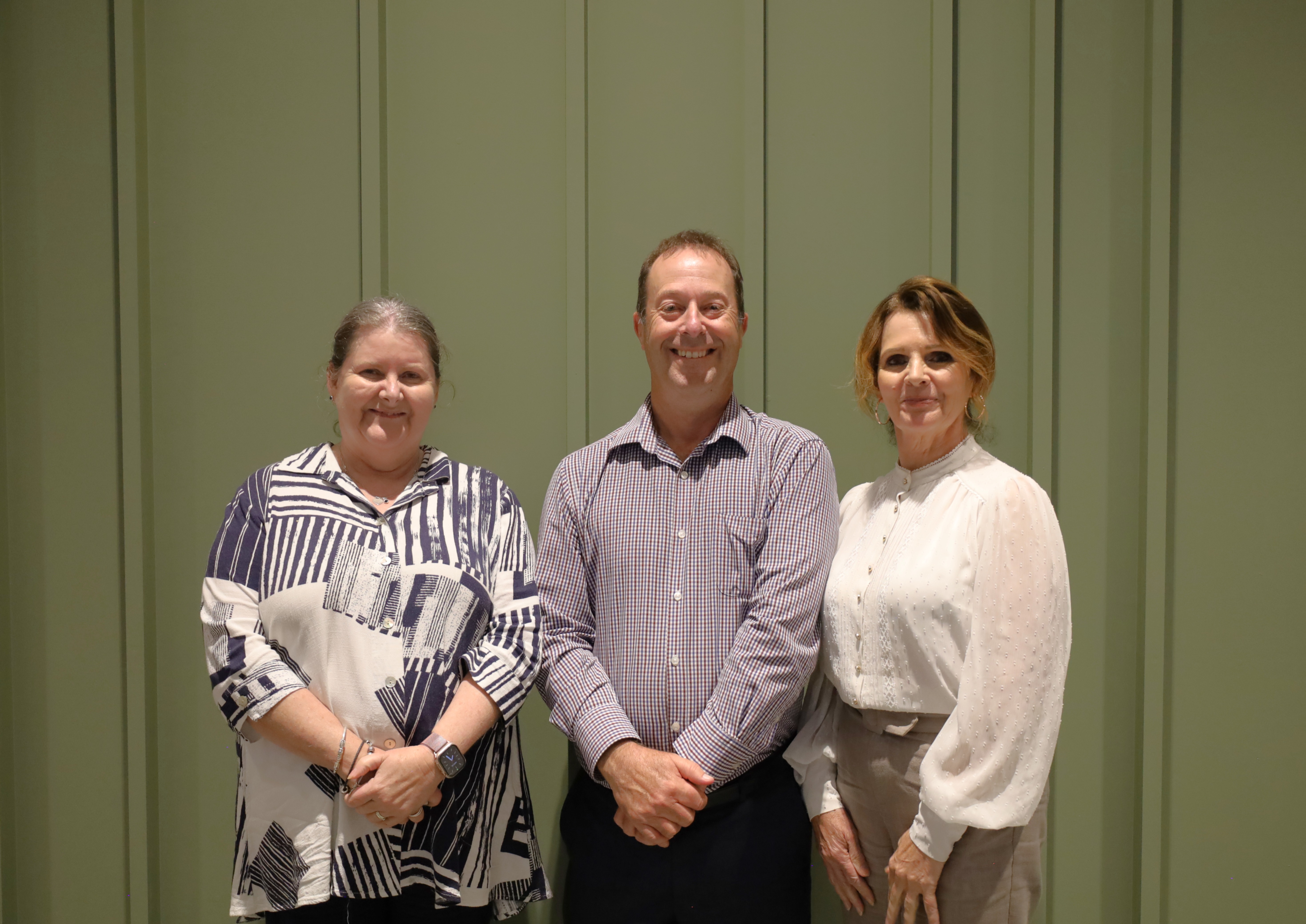Mayor Kylie Boston, Incoming CEO Gary Button and Deputy Mayor Cr. Karen Turnbull stand together in front of a green backgound.